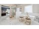 Bright bathroom featuring a soaking tub, glass shower, and marble flooring at 3998 Commodore Dr, Atlanta, GA 30341