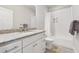 Modern bathroom featuring white vanity with granite countertop and shower with white subway tile at 3998 Commodore Dr, Atlanta, GA 30341