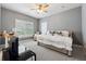 Stylish bedroom with grey walls, comfortable bed, and window with bright, shutter-style blinds at 3998 Commodore Dr, Atlanta, GA 30341