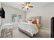 Cozy bedroom features a plush bed, ceiling fan, and bright window with shutter-style blinds at 3998 Commodore Dr, Atlanta, GA 30341