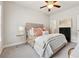Inviting bedroom features a soft bed with decorative pillows, ceiling fan, and modern side table at 3998 Commodore Dr, Atlanta, GA 30341