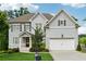 Charming two-story home featuring a well-manicured lawn and a two-car garage at 3998 Commodore Dr, Atlanta, GA 30341