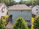 Back exterior view of a two-story home, complete with a deck and covered patio area at 3998 Commodore Dr, Atlanta, GA 30341