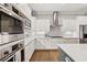 Bright kitchen boasts stainless appliances, white cabinets, countertops and subway tile backsplash at 3998 Commodore Dr, Atlanta, GA 30341