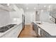 Bright kitchen features stainless appliances, white cabinets, gray island, and hardwood floors at 3998 Commodore Dr, Atlanta, GA 30341