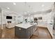 Open concept kitchen features stainless steel appliances, white cabinetry, and large kitchen island at 3998 Commodore Dr, Atlanta, GA 30341