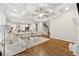 Open concept living area features a coffered ceiling, hardwood floors, and lots of seating at 3998 Commodore Dr, Atlanta, GA 30341