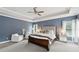 Spacious main bedroom featuring a tray ceiling, plush bed, and large windows with natural light at 3998 Commodore Dr, Atlanta, GA 30341