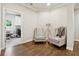 Sitting room with hardwood floors and patterned chairs, open to a laundry room at 3998 Commodore Dr, Atlanta, GA 30341