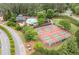 Aerial image displays a pool and tennis courts in a community, close to mature trees at 1313 Cobblestone Ln, Woodstock, GA 30189