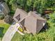 Aerial view of home showing well-maintained roof, landscaping, and a private driveway at 1313 Cobblestone Ln, Woodstock, GA 30189