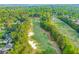 Scenic aerial view of the golf course with lush green fairways and mature trees in a beautiful community at 1313 Cobblestone Ln, Woodstock, GA 30189