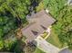 Aerial view of a home with a well-maintained roof, lush landscaping, and a private driveway at 1313 Cobblestone Ln, Woodstock, GA 30189