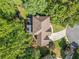 Aerial view of a home with a well-maintained roof, lush landscaping, and a private driveway at 1313 Cobblestone Ln, Woodstock, GA 30189