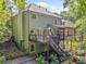 Backyard view featuring a deck with outdoor seating and lush landscaping at 1313 Cobblestone Ln, Woodstock, GA 30189