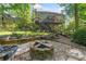 Expansive backyard featuring lush landscaping, a fire pit, and ample space for entertaining at 1313 Cobblestone Ln, Woodstock, GA 30189