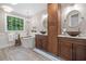 Beautiful bathroom with a soaking tub next to a large window for natural light at 1313 Cobblestone Ln, Woodstock, GA 30189