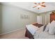 Bright bedroom featuring a ceiling fan, neutral walls, carpeted floors, and decor at 1313 Cobblestone Ln, Woodstock, GA 30189