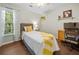 Cozy bedroom with wood floors, a window view, and decorative accents at 1313 Cobblestone Ln, Woodstock, GA 30189