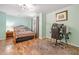 Bedroom featuring hardwood floors, natural light, and a dedicated workspace at 1313 Cobblestone Ln, Woodstock, GA 30189