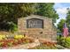 Community entrance sign with stone detail and colorful landscaping at 1313 Cobblestone Ln, Woodstock, GA 30189