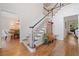 Elegant foyer with hardwood floors and a staircase featuring a decorative stair runner at 1313 Cobblestone Ln, Woodstock, GA 30189