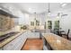 Bright kitchen with white cabinetry, granite countertops, stainless steel appliances, and wood floors at 1313 Cobblestone Ln, Woodstock, GA 30189