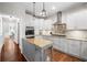Updated kitchen featuring an island, granite countertops, and stainless steel appliances at 1313 Cobblestone Ln, Woodstock, GA 30189