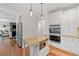 Open kitchen design with granite countertops, stainless steel appliances, and wood flooring at 1313 Cobblestone Ln, Woodstock, GA 30189