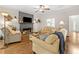 Cozy living room featuring a fireplace, ceiling fan, and comfortable seating area at 1313 Cobblestone Ln, Woodstock, GA 30189