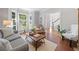 Cozy living room with ample natural light and hardwood floors at 1313 Cobblestone Ln, Woodstock, GA 30189