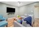 Stylish living room featuring modern furniture, wall-mounted TV, and wood-look floors at 1313 Cobblestone Ln, Woodstock, GA 30189