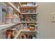 Pantry with shelves for storing canned goods, containers, and other supplies at 1313 Cobblestone Ln, Woodstock, GA 30189