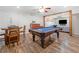Spacious recreation room with pool table, dining table, and living room area at 1313 Cobblestone Ln, Woodstock, GA 30189