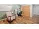 Finished room with wood floors, closet, and a pegboard wall at 1313 Cobblestone Ln, Woodstock, GA 30189