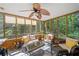 Comfortable screened-in porch with ceiling fan and scenic wooded views at 1313 Cobblestone Ln, Woodstock, GA 30189