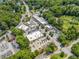 Aerial view of businesses surrounded by lush trees, roadways, and parking at 1482 N Decatur Ne Rd, Atlanta, GA 30306