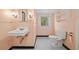 Quaint bathroom features black and white tiled floors, pedestal sink and white commode at 1482 N Decatur Ne Rd, Atlanta, GA 30306