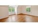 Bright bedroom features hardwood floors and plenty of natural light from the large windows at 1482 N Decatur Ne Rd, Atlanta, GA 30306