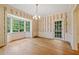 Elegant dining room with hardwood floors, bay windows, chandelier, and decorative wallpaper at 1482 N Decatur Ne Rd, Atlanta, GA 30306