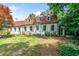Classic two-story home with white siding, a brick roof, shutters, and mature landscaping at 1482 N Decatur Ne Rd, Atlanta, GA 30306