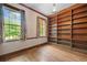 Cozy library with built-in bookshelves, hardwood floors, and two windows overlooking the backyard at 1482 N Decatur Ne Rd, Atlanta, GA 30306