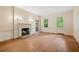 Bright living room featuring hardwood floors, a fireplace, and large windows with backyard views at 1482 N Decatur Ne Rd, Atlanta, GA 30306