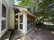 Enclosed porch with screens and white wood framing sits adjacent to a brick home at 1482 N Decatur Ne Rd, Atlanta, GA 30306