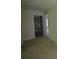 Bedroom with neutral carpet and a view into the en suite bathroom at 2307 Overlook Ave, Lithonia, GA 30058