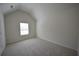 A cozy bedroom featuring neutral walls, carpet and a window at 2307 Overlook Ave, Lithonia, GA 30058