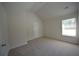 An empty bedroom featuring neutral walls, carpet and a window at 2307 Overlook Ave, Lithonia, GA 30058