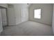 A bright bedroom featuring neutral walls, carpet, a window and 2 door ways at 2307 Overlook Ave, Lithonia, GA 30058