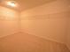 Walk-in closet with ample storage space on carpeted floor at 2307 Overlook Ave, Lithonia, GA 30058