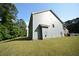 Exterior side view of home featuring neutral siding and a well-manicured lawn at 2307 Overlook Ave, Lithonia, GA 30058